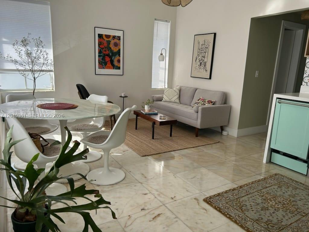 A living and dining area features white tile floors, a grey sofa, and a round table — 801 8th St # 201, Miami Beach FL 33139, MIAMI BEACH, FL