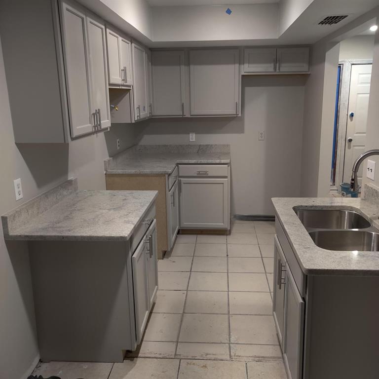 A kitchen with light gray cabinets, granite countertops, and tile flooring under construction — 722 W COLUMBIA AVENUE UNIT 722, KISSIMMEE, FL