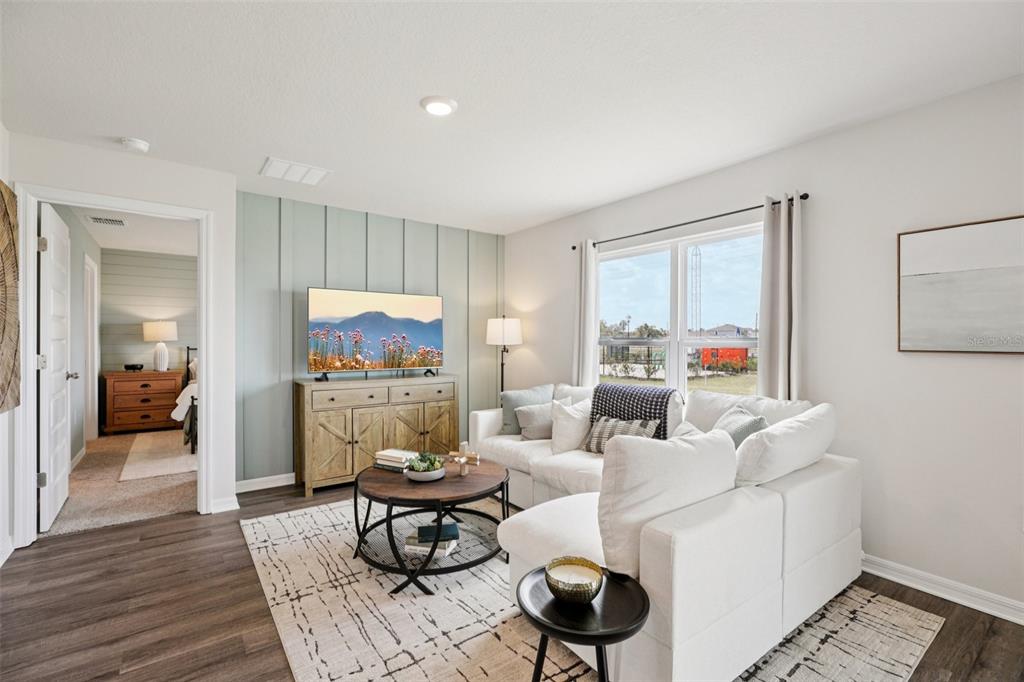 A living room features a white sectional sofa, a wood coffee table, and board-and-batten wall — 734 GREENWAY BOULEVARD, LAKE WALES, FL