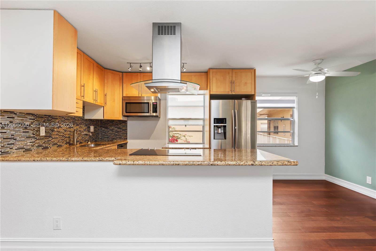 A kitchen with light wood cabinets, granite countertops, stainless steel appliances, and a breakfast bar — 854 Normandy R # 854, Delray Beach FL 33484, DELRAY BEACH, FL