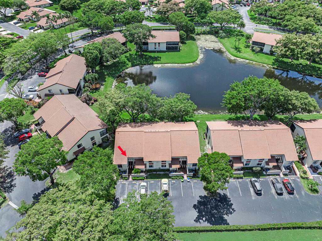 An aerial view shows a multi-unit residential building with a red arrow pointing to a unit — 10851 Palm Lake Avenue # 101, Boynton Beach FL 33437, BOYNTON BEACH, FL