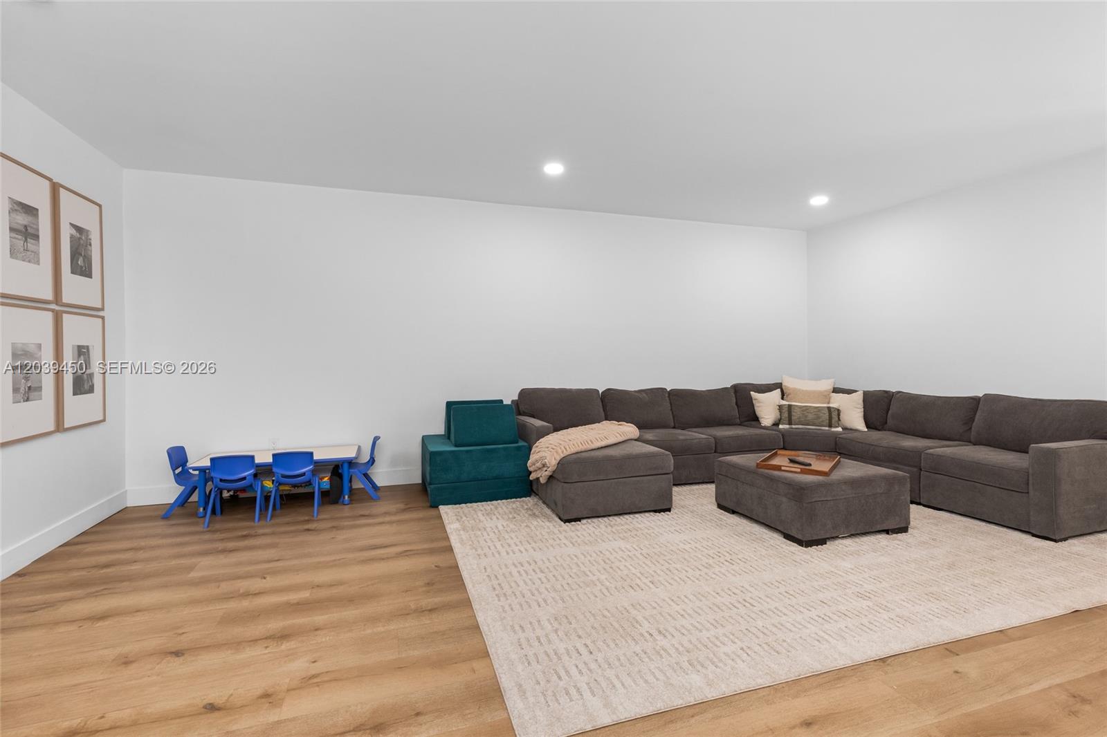A living room features a large gray sectional sofa, a matching ottoman, and a children's table — 3125 Jackson Ave # 3125, Miami FL 33133, MIAMI, FL