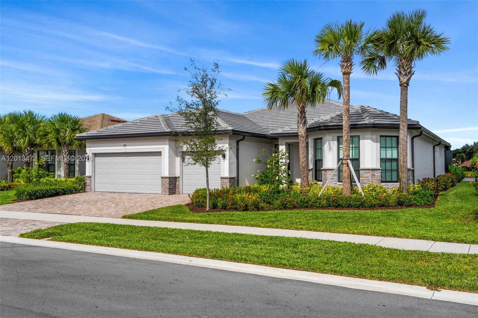 A single-story house with a two-car garage, tile roof, and palm trees in the front — 2715 Primrose Pl, Oakland Park FL 33309, OAKLAND PARK, FL