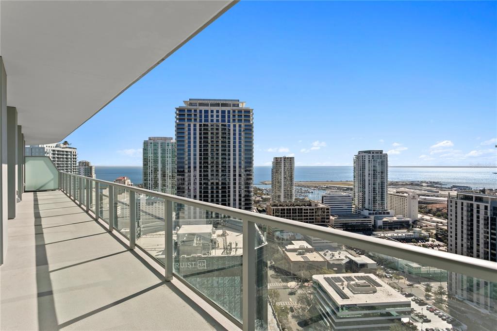 A high-rise balcony overlooks a city skyline and a body of water — 400 CENTRAL AVENUE UNIT 2806, ST PETERSBURG, FL