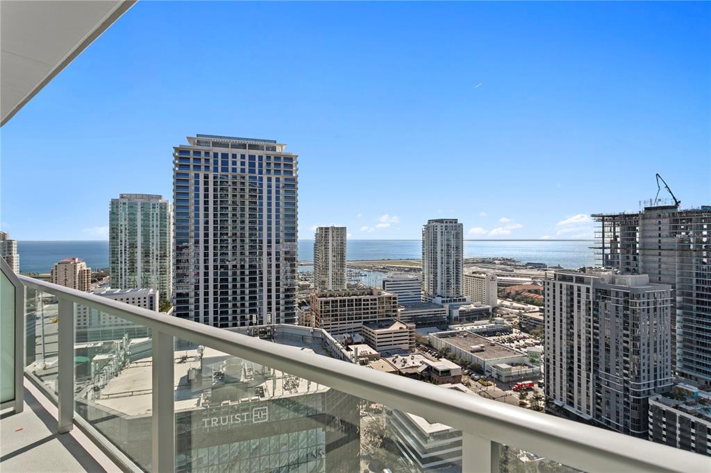 A high-rise balcony offers a panoramic view of a city skyline and the ocean — 400 CENTRAL AVENUE UNIT 2806, ST PETERSBURG, FL