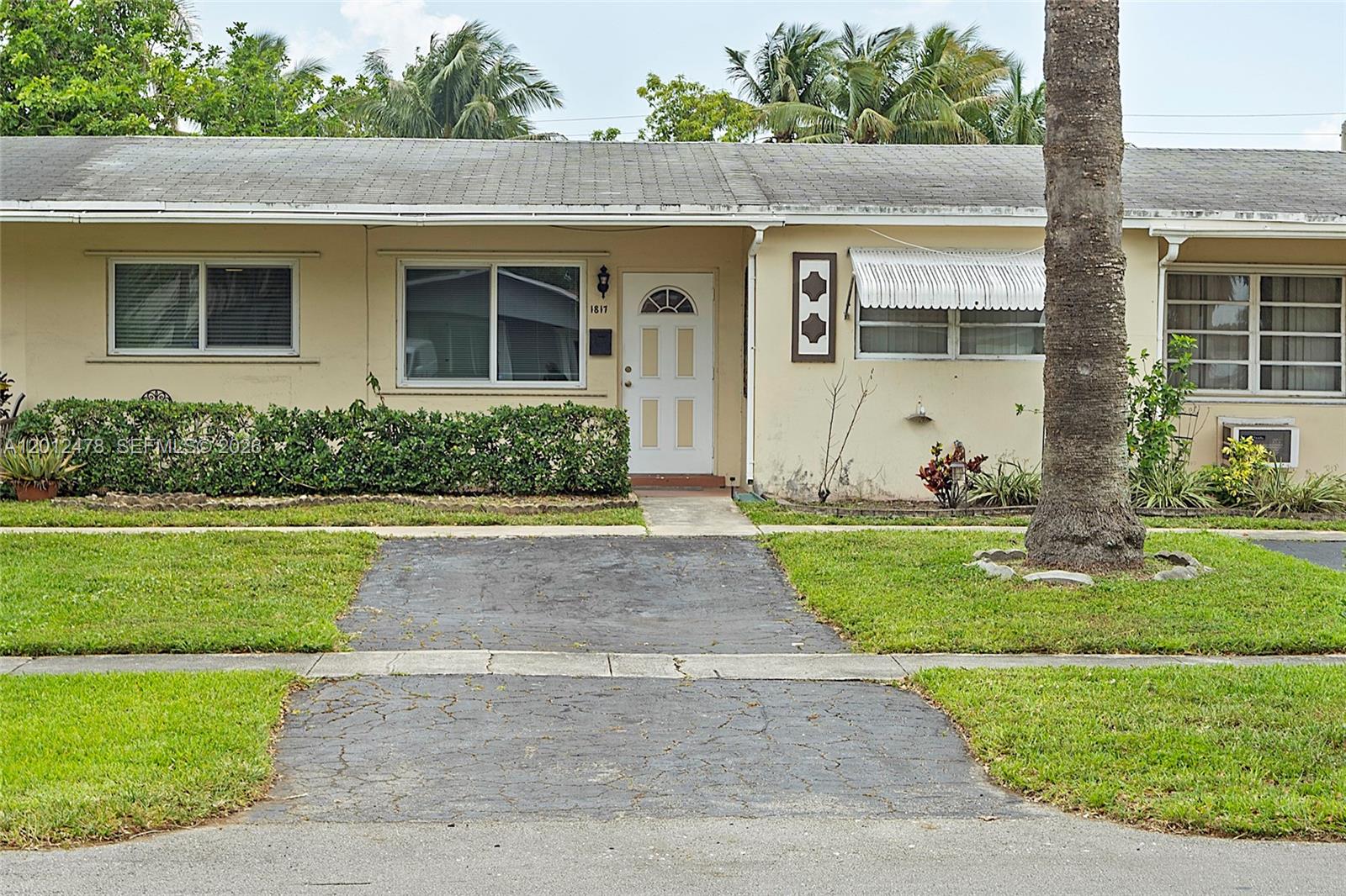 A single-story house with a paved driveway, a white front door, and a palm tree — 1817 NW 60th Ave # G, Sunrise FL 33313, SUNRISE, FL