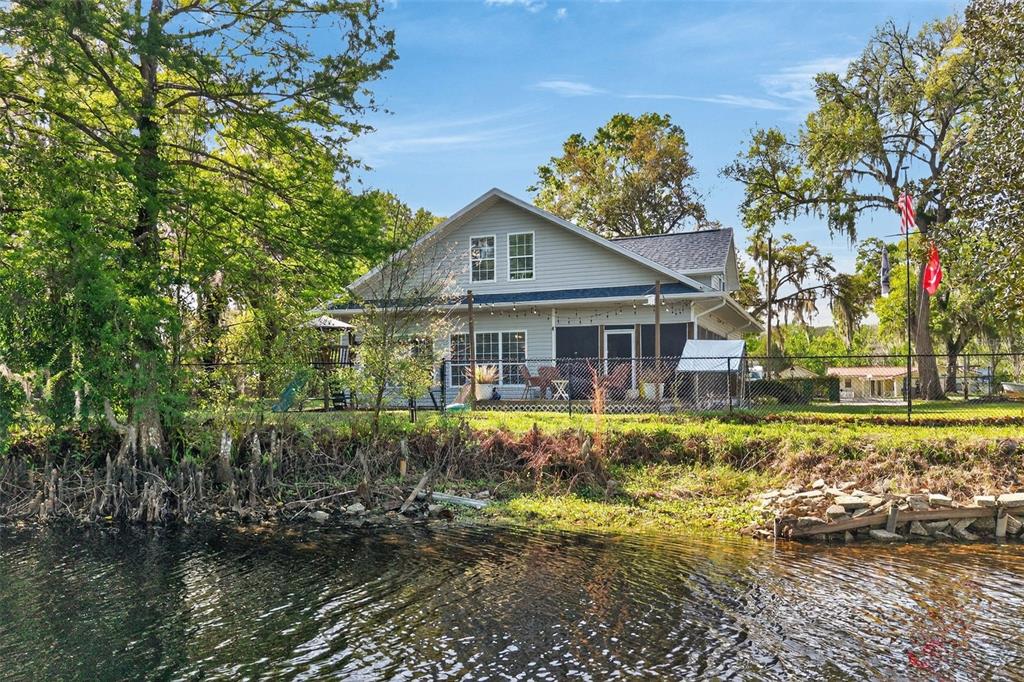 The exterior of a two-story house features a large covered porch with wooden support posts — 5572 S MARLIN POINT, FLORAL CITY, FL