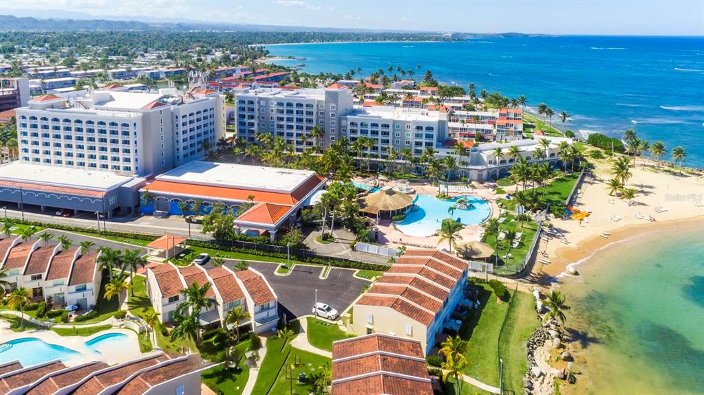 An aerial view of a large beachfront resort complex with multiple buildings and swimming pools — Dorado del Mar Blvd OCEAN VILLAS UNIT 39, DORADO, PR