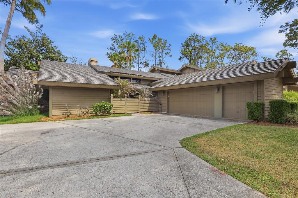 A tan, single-story house with a multi-car garage and a concrete driveway — 5344 COBBLESTONE COURT, WESLEY CHAPEL, FL