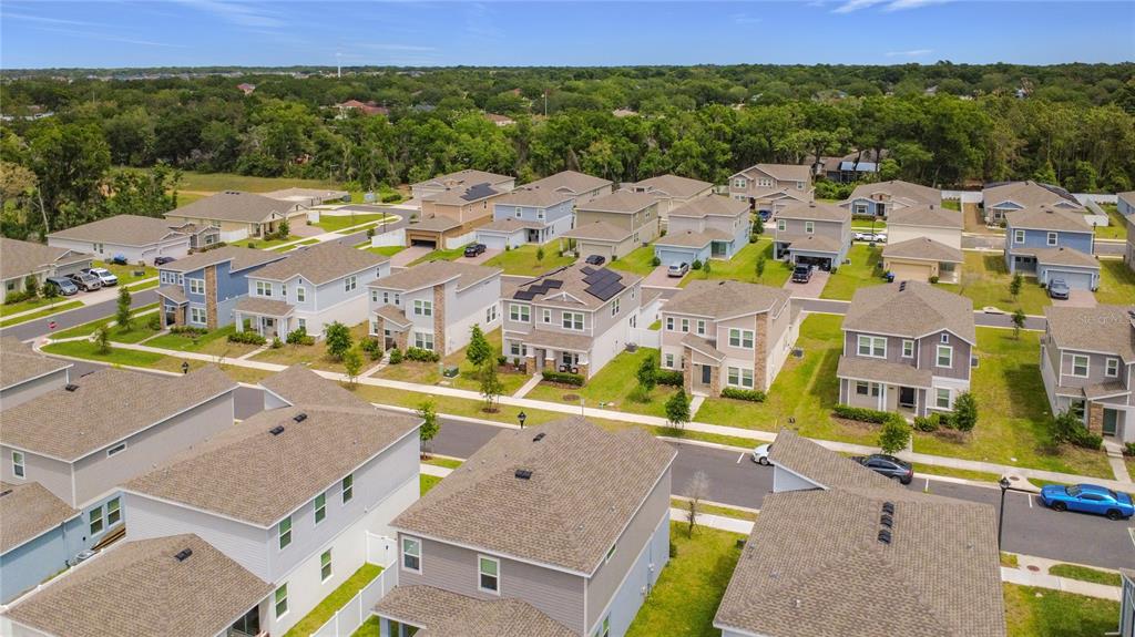 An aerial view shows a suburban neighborhood with multiple two-story houses and paved streets — 2195 SWEET HONEY LANE, APOPKA, FL