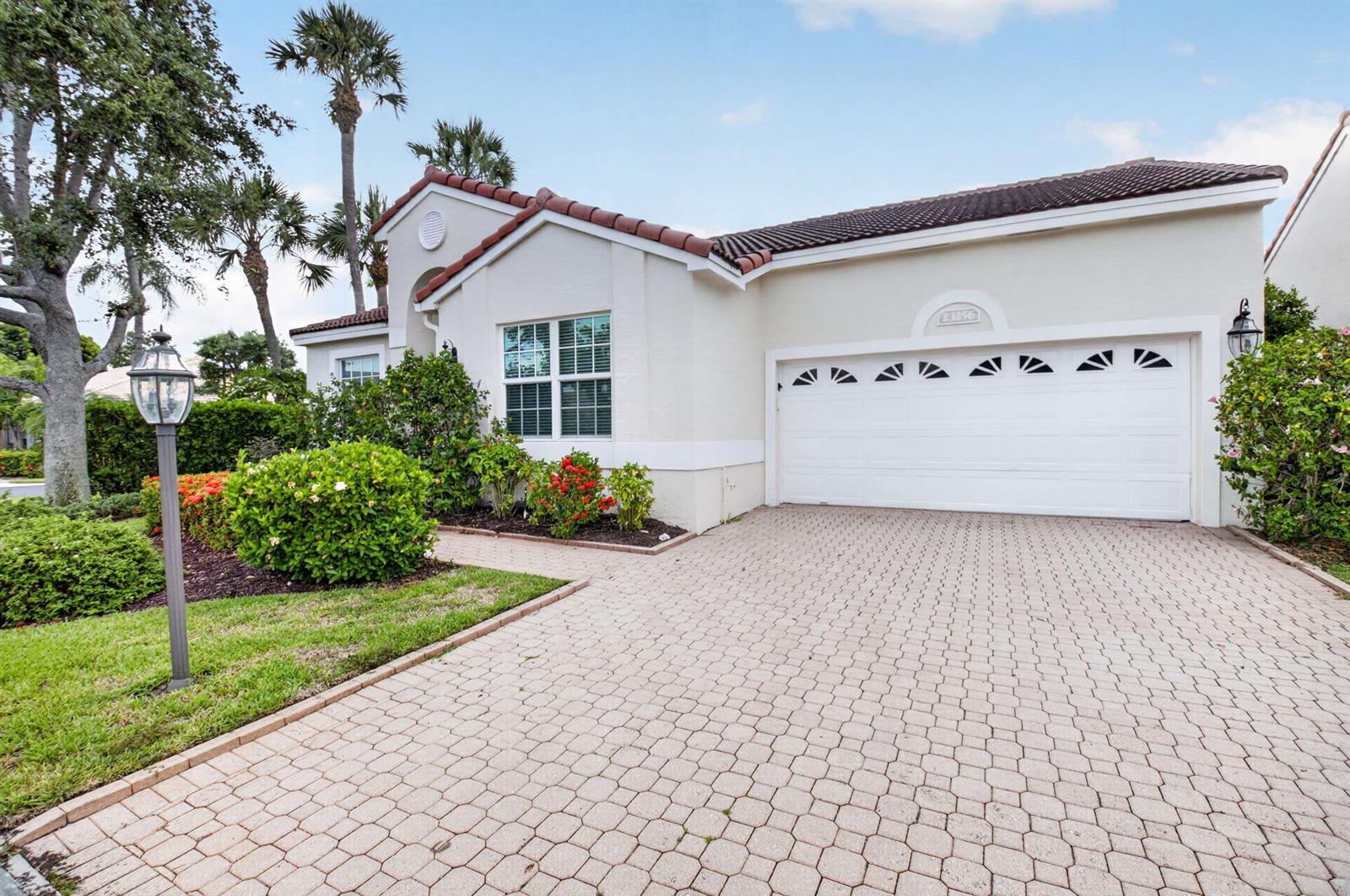 A single-story house with a paved driveway, a two-car garage, and landscaped front yard — 23256 Alora Drive, Boca Raton FL 33433, BOCA RATON, FL