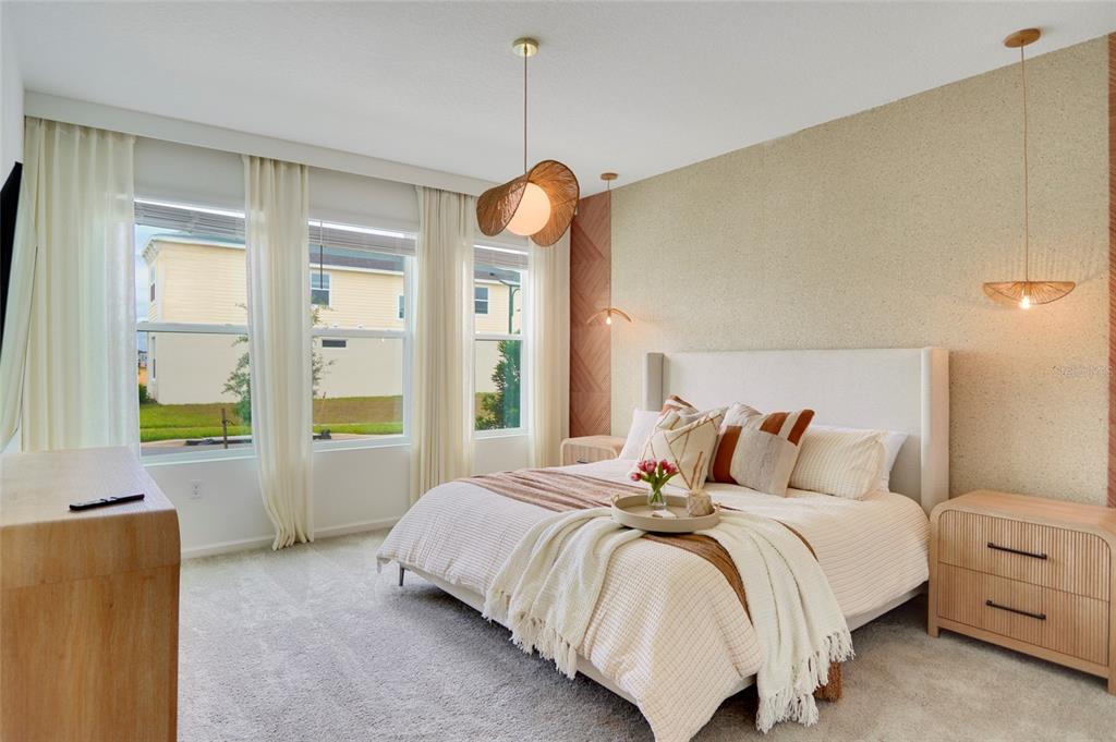 A bedroom features a bed with neutral bedding, textured accent wall, and hanging pendant lights — 9194 SEASCAPE COVE, KISSIMMEE, FL