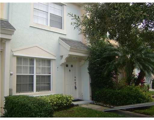A light blue two-story townhouse exterior features a white front door and a large window — 51 Whitehead Circle # 51, Weston FL 33326, WESTON, FL