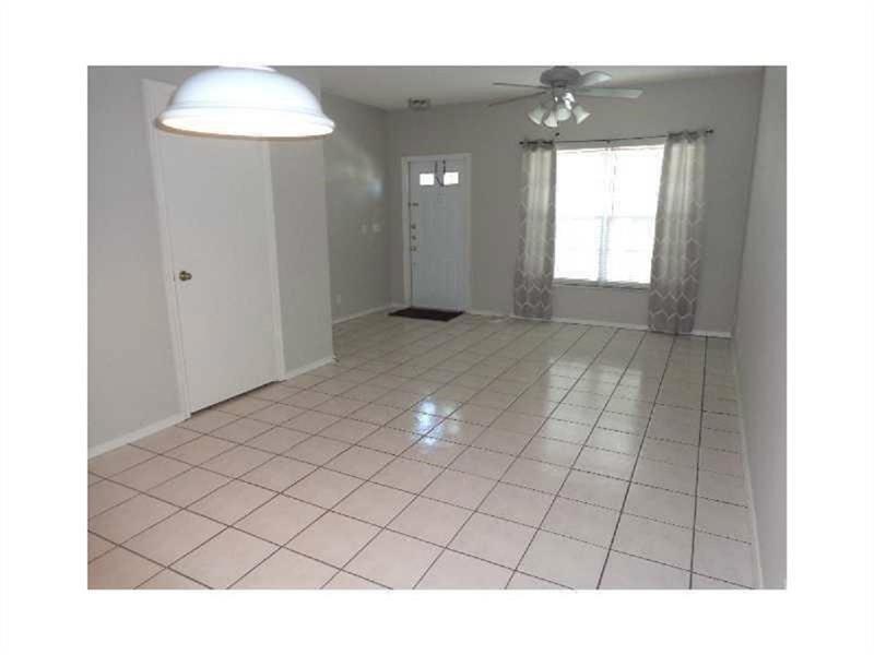 A room with light-colored tile flooring, a white door, and a ceiling fan with lights — 51 Whitehead Circle # 51, Weston FL 33326, WESTON, FL