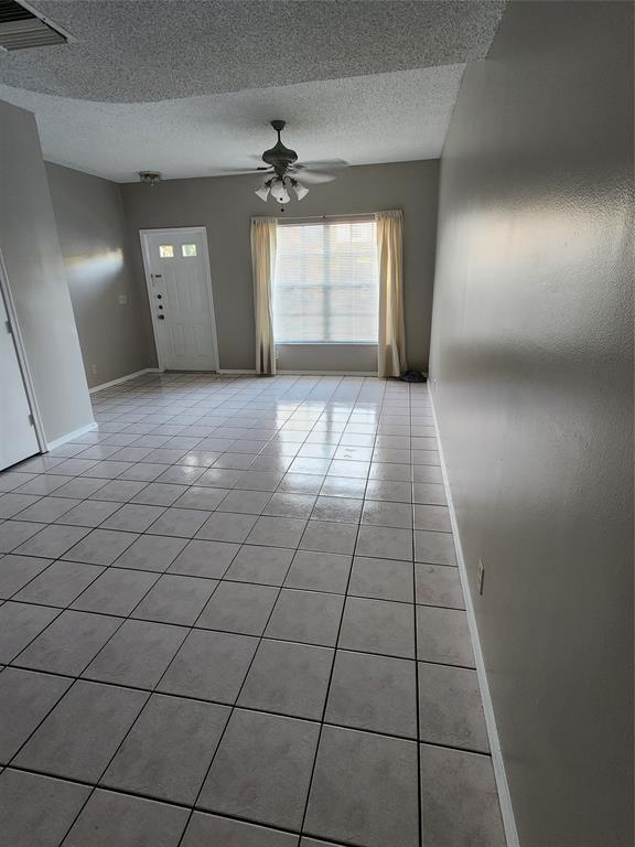 A living room features light-colored floor tiles, a ceiling fan, and a window with curtains — 51 Whitehead Circle # 51, Weston FL 33326, WESTON, FL