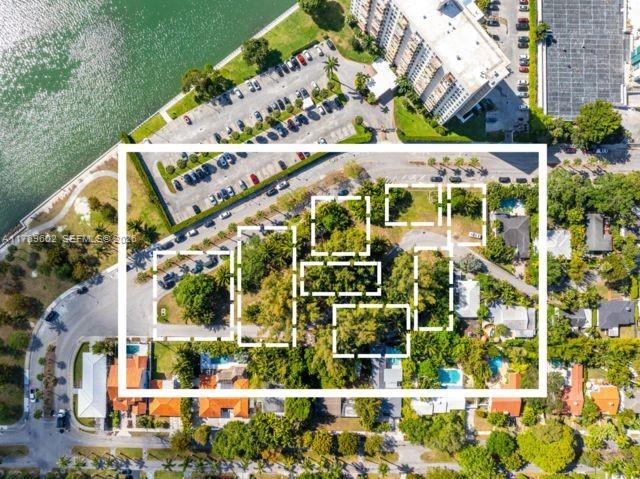 This aerial map shows a residential area with highlighted property boundaries and nearby parking lots — 890 NE 70th St, Miami FL 33138, MIAMI, FL