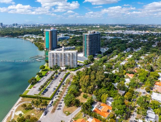 An aerial view shows high-rise apartment buildings situated along a waterfront with a parking lot — 890 NE 70th St, Miami FL 33138, MIAMI, FL