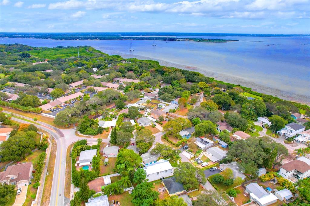An aerial view shows a residential neighborhood situated along a large body of water — 1105 CONANT AVENUE, SAFETY HARBOR, FL