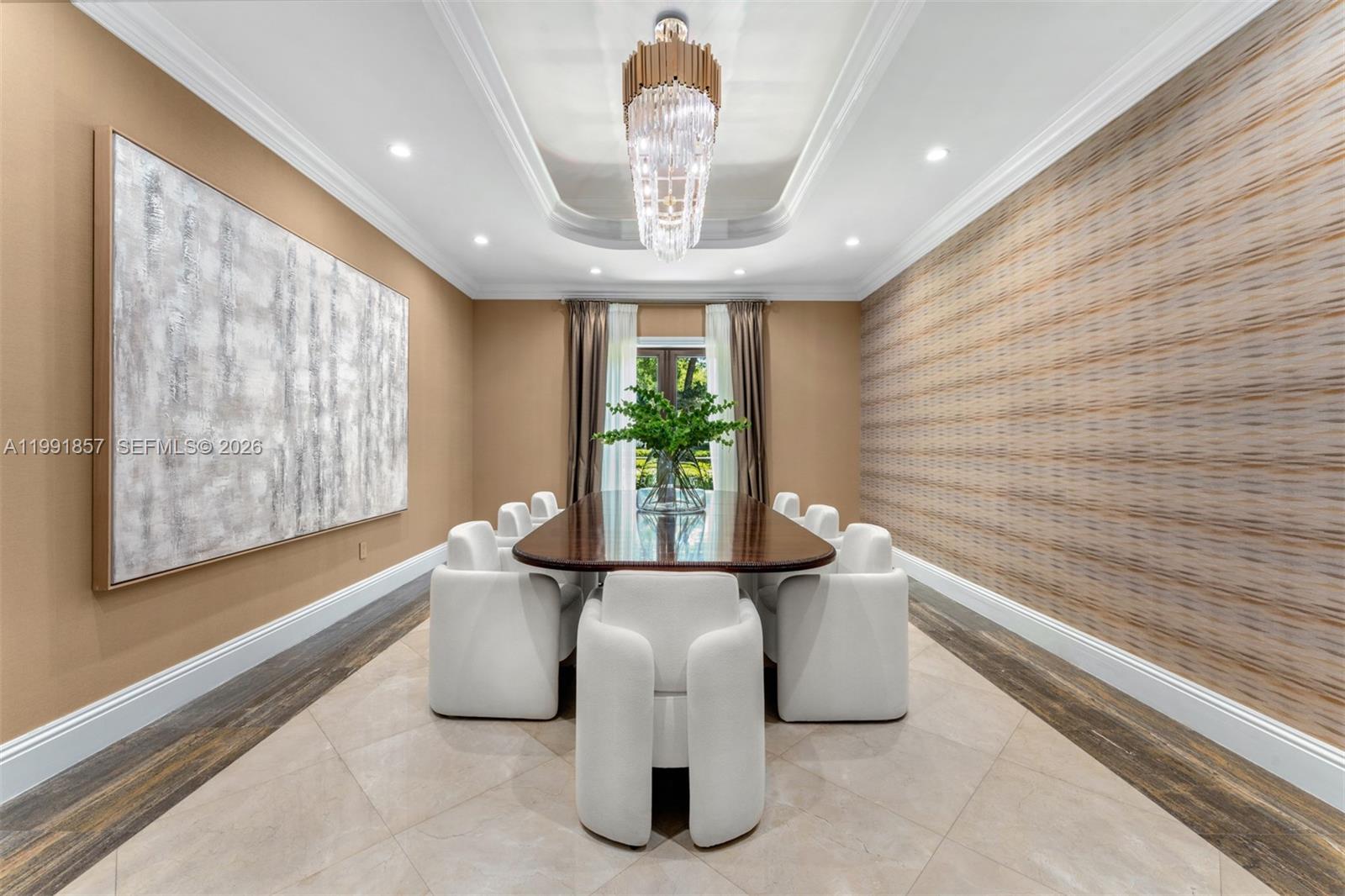 A formal dining room features a long table, white chairs, a chandelier, and textured wallpaper — 12575 Pine Needle Ln, Pinecrest FL 33156, PINECREST, FL