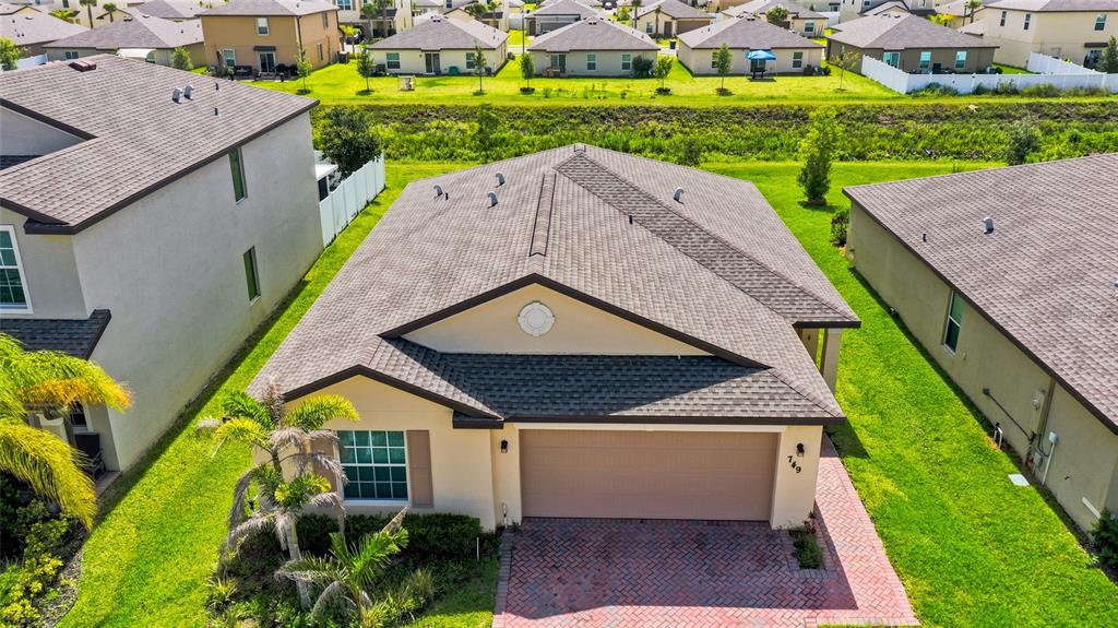 An aerial view shows the front exterior of a single-story house with a garage — 749 WORLINGTON LANE, FORT PIERCE, FL