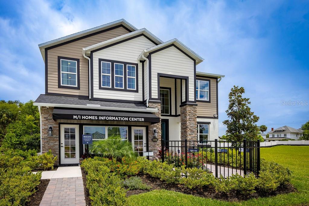 A two-story house with stone and siding exterior serves as an M/I Homes information center — 1205 BASALT LANE, SANFORD, FL