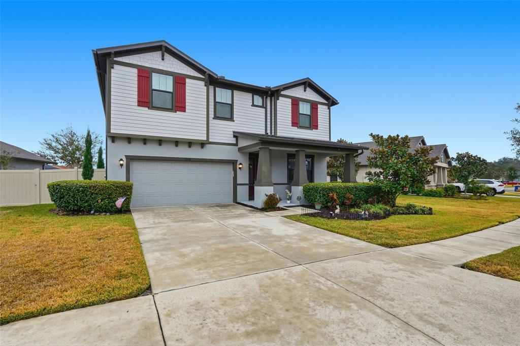 A two-story house with a gray garage, white siding, and a covered front porch — 13338 NEWPORT SHORES DRIVE, HUDSON, FL