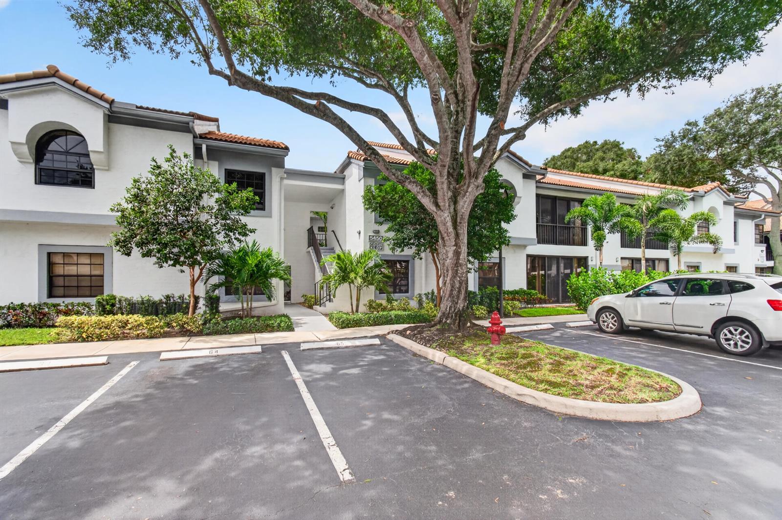 A two-story apartment building with white stucco walls, a tile roof, and a parking lot — 5450 Verona Drive # P, Boynton Beach FL 33437, BOYNTON BEACH, FL