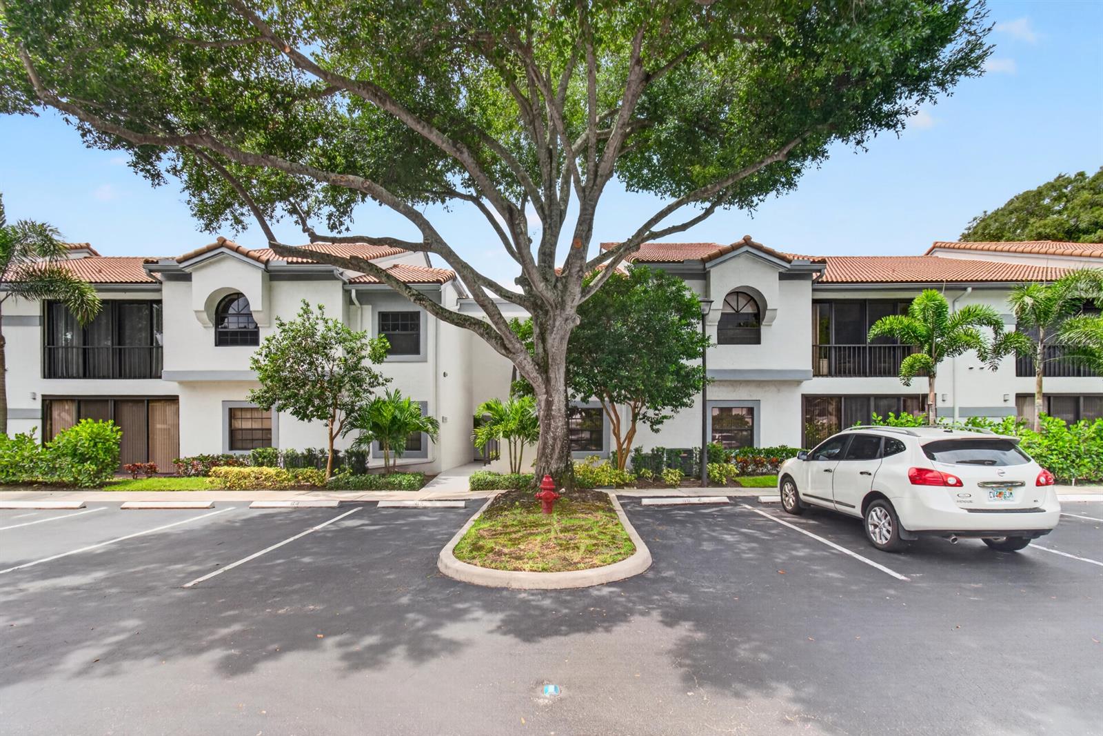 A two-story residential building with a large tree and a parking lot in front — 5450 Verona Drive # P, Boynton Beach FL 33437, BOYNTON BEACH, FL