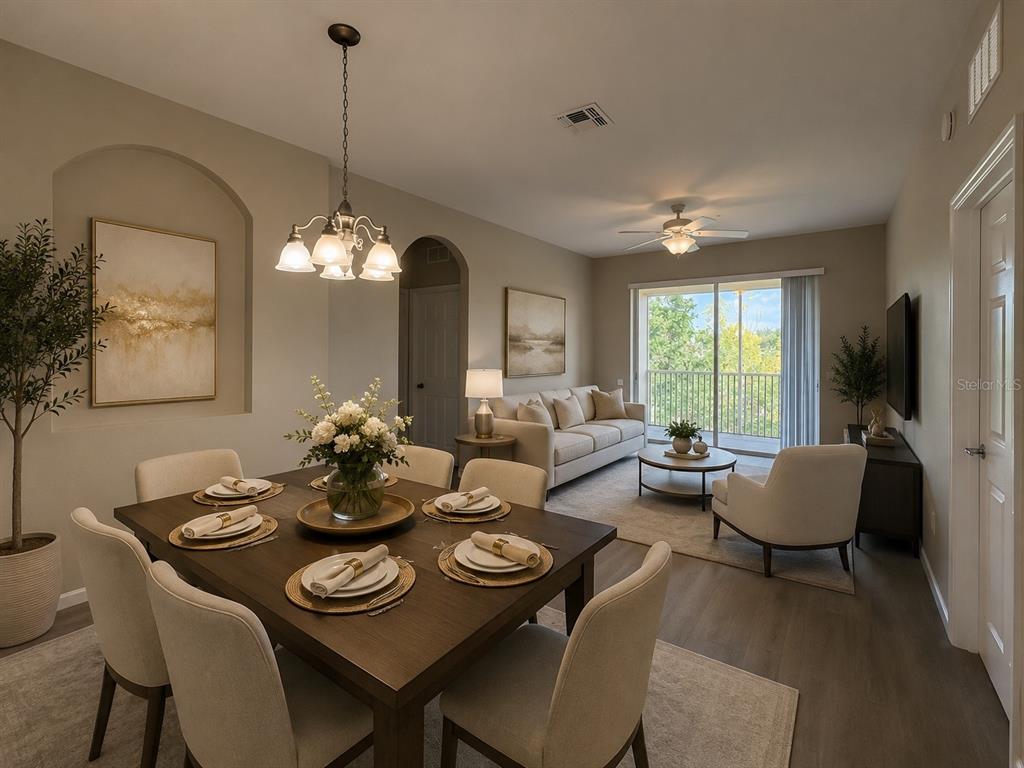 A dining area with a dark wood table opens into a living room with balcony access — 3314 ROBERT TRENT JONES DRIVE UNIT 406, ORLANDO, FL