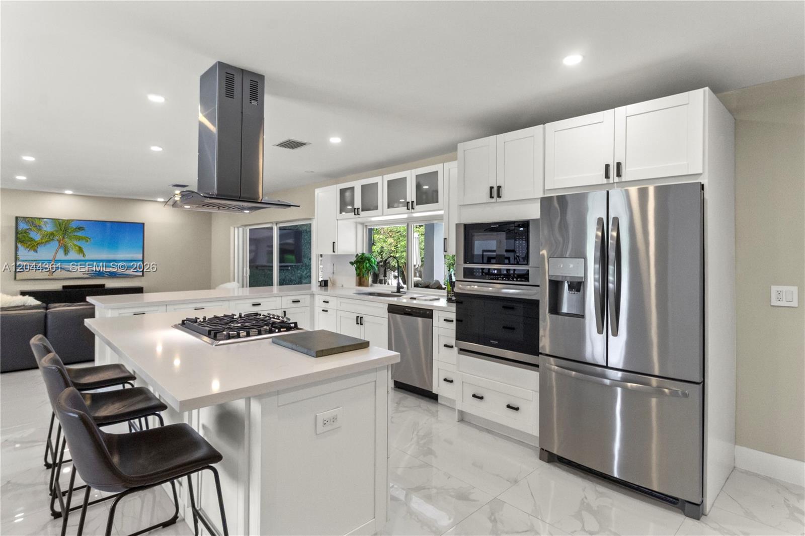 A backyard patio features a swimming pool, covered seating area, and light-colored tile flooring — 12900 SW 112th Ave, Miami FL 33176, MIAMI, FL