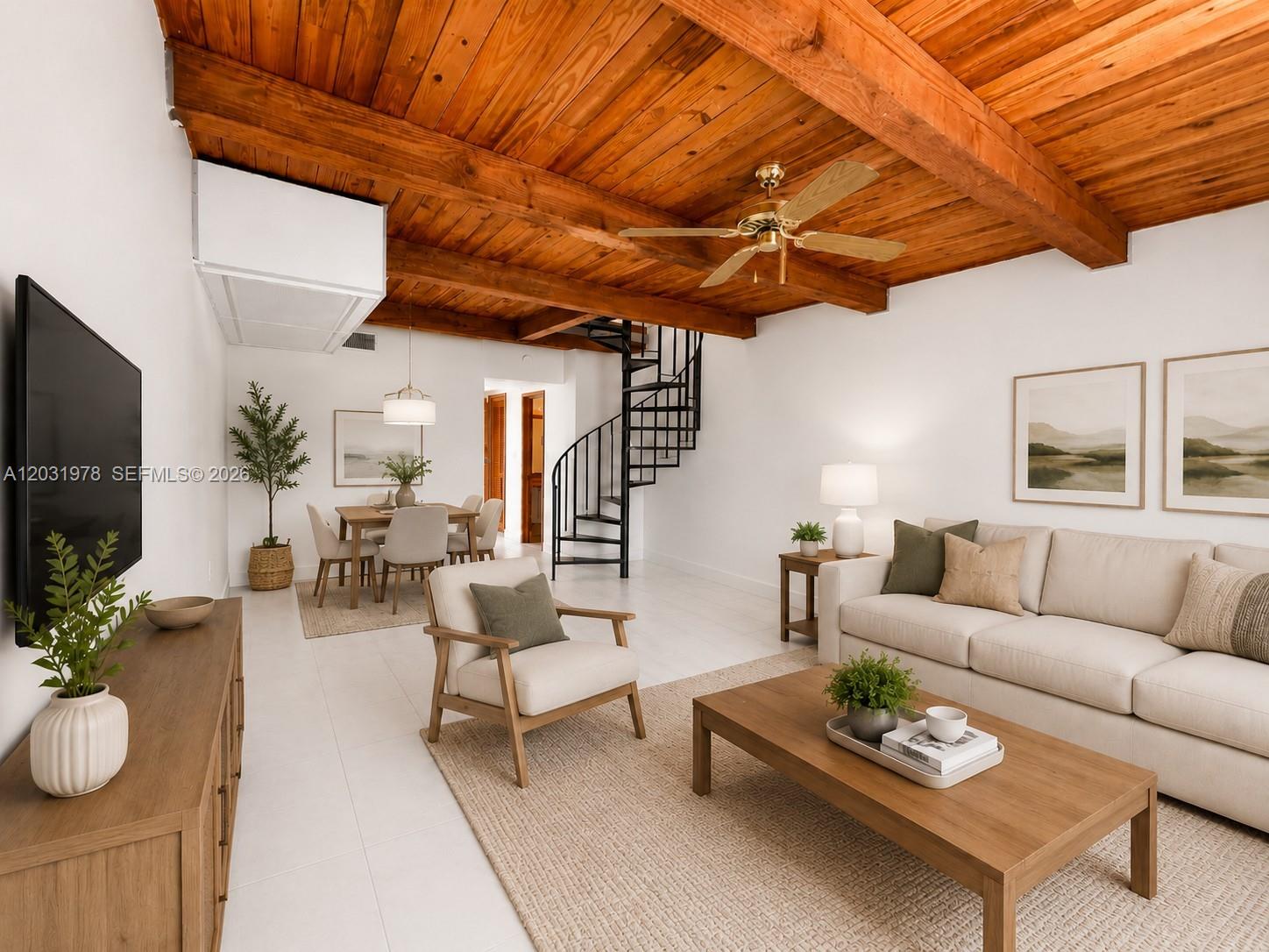 A living room features a wood-beamed ceiling, white walls, a spiral staircase, and neutral furniture — 3719 Riverside Dr, Coral Springs FL 33065, CORAL SPRINGS, FL