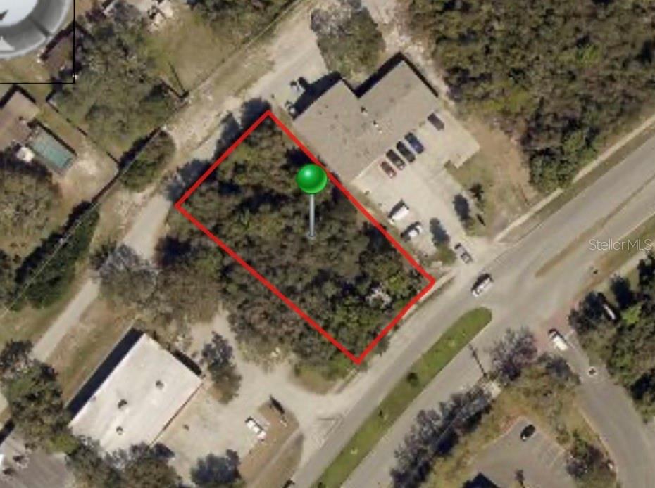 This aerial map shows a rectangular, wooded vacant lot outlined in red — 2766 ELKCAM BOULEVARD, DELTONA, FL