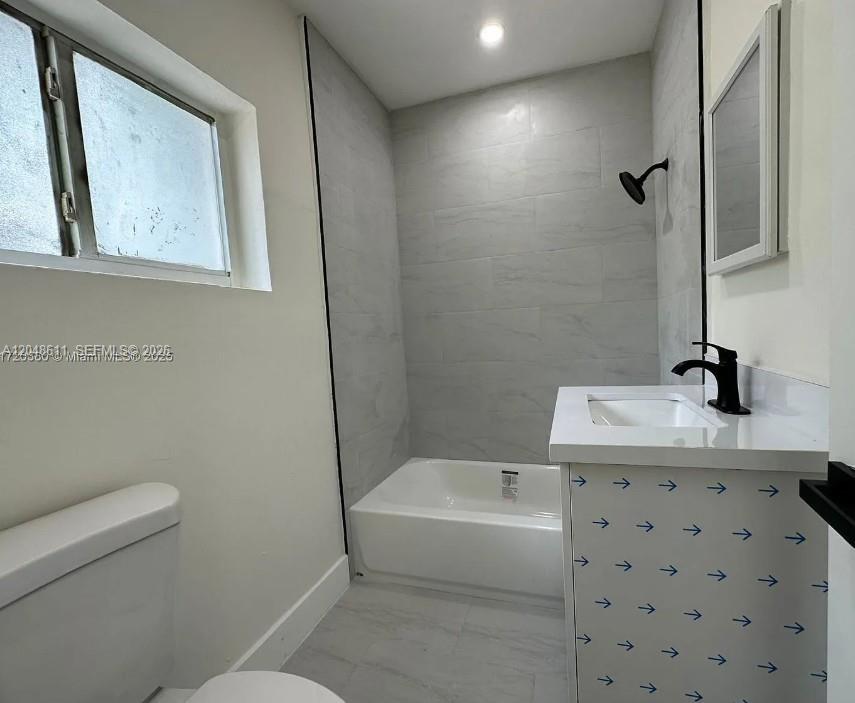 A bathroom features a white vanity with a black faucet, a tub, and tiled walls — 1514 SW 6th St # 4, Miami FL 33135, MIAMI, FL