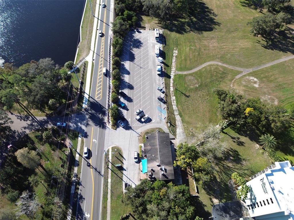 Aerial view of a parking lot next to a building, a road, and a waterway — 1200 8TH AVENUE SW UNIT 1, LARGO, FL