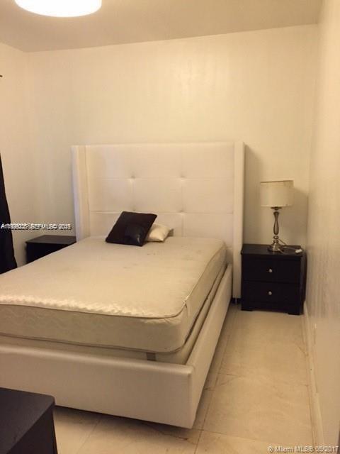A bedroom features a white tufted headboard, a mattress, and two black nightstands — 842 Meridian Ave # 1B, Miami Beach FL 33139, MIAMI BEACH, FL