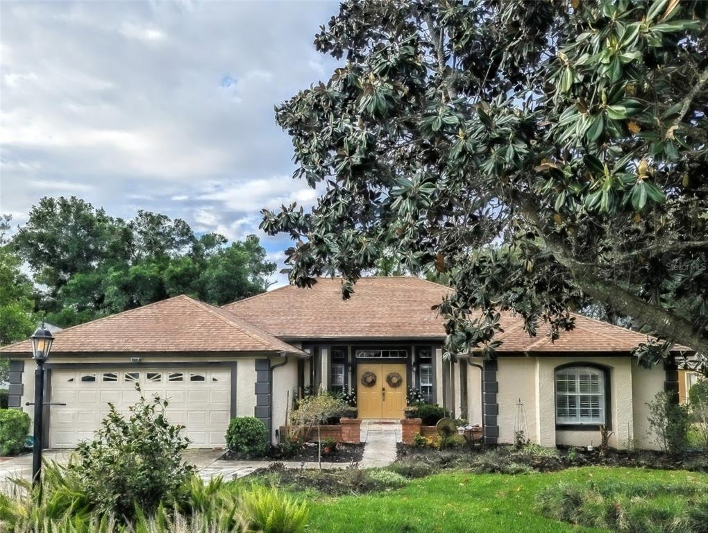 A spacious open-concept living room features a large sectional sofa, dining area, and pool table — 39819 GROVE HEIGHTS, LADY LAKE, FL