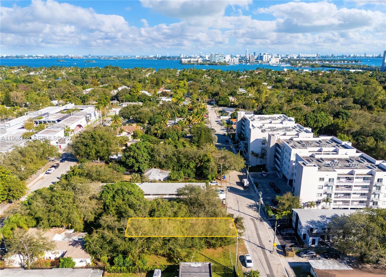 An aerial view shows a rectangular vacant lot highlighted in yellow amidst a suburban neighborhood — 729 NE 85th St, Miami FL 33138, MIAMI, FL