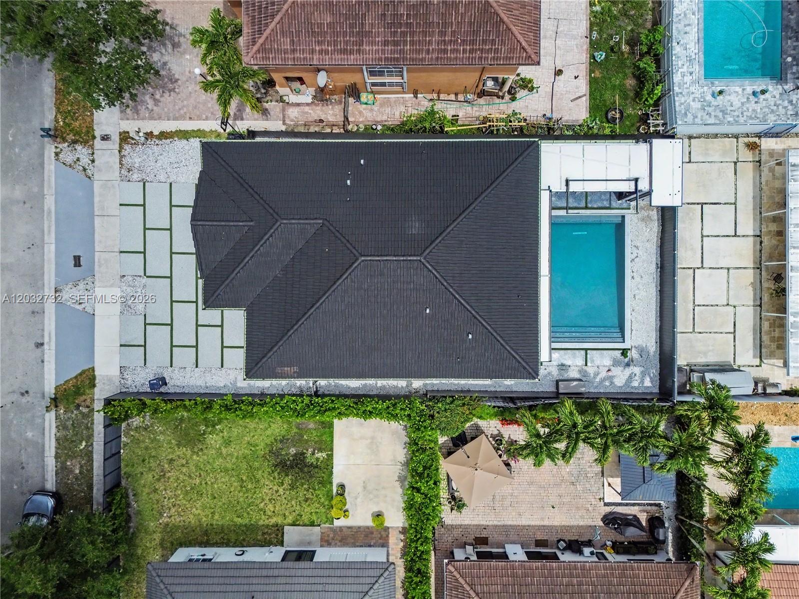 An aerial view shows a house with a dark roof, a pool, and a paved driveway — 15490 SW 18th Ln, Miami FL 33185, MIAMI, FL