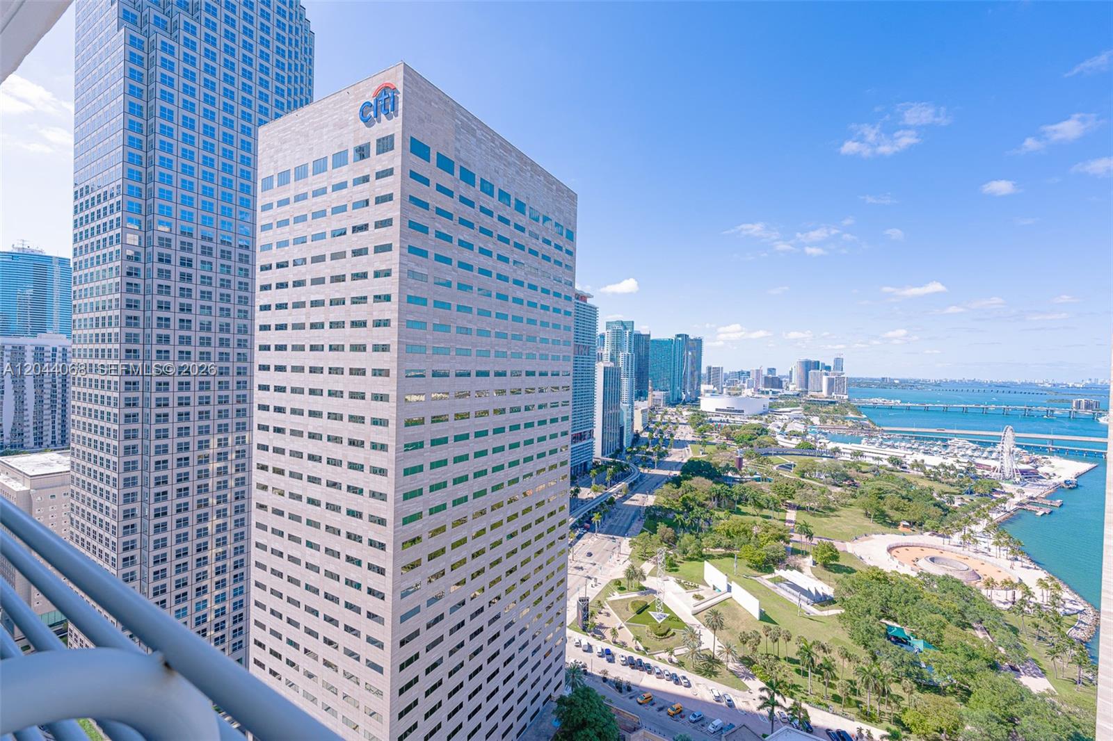 An elevated exterior view of a city skyline featuring a prominent Citi office building — 325 S Biscayne Blvd # 3624, Miami FL 33131, MIAMI, FL