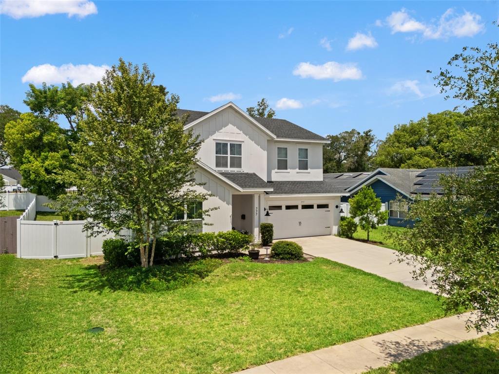 A two-story white house with a dark roof and a two-car garage — 777 HALIFAX AVENUE, WINTER PARK, FL