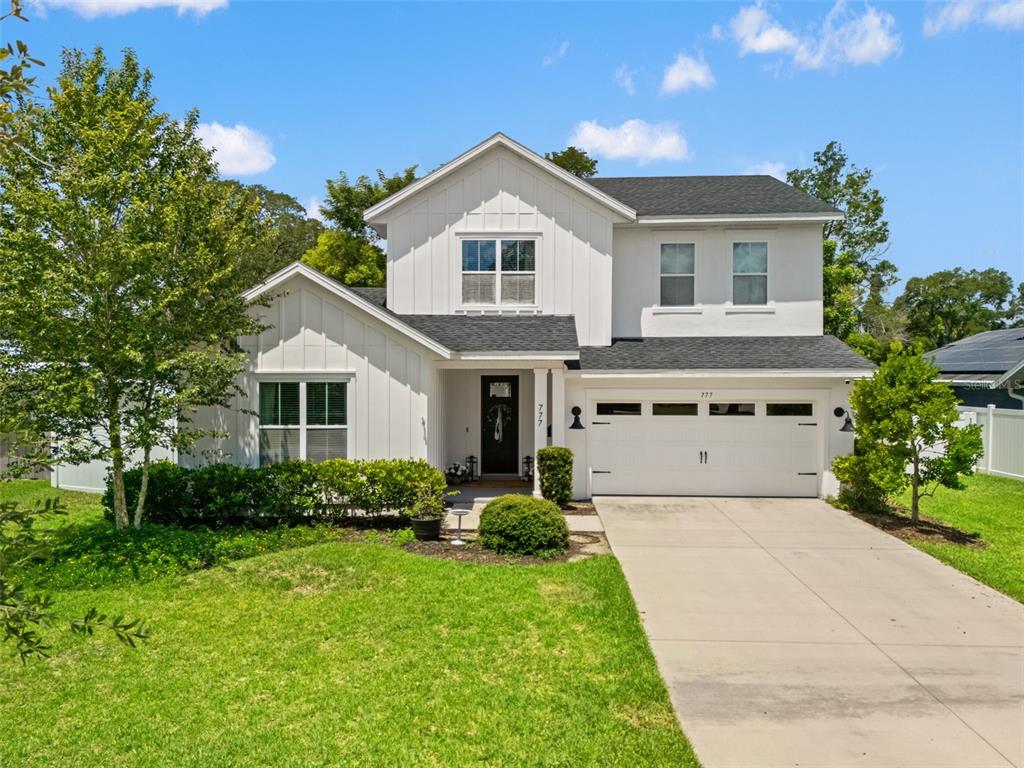 A two-story white house with a gabled roof and an attached two-car garage — 777 HALIFAX AVENUE, WINTER PARK, FL