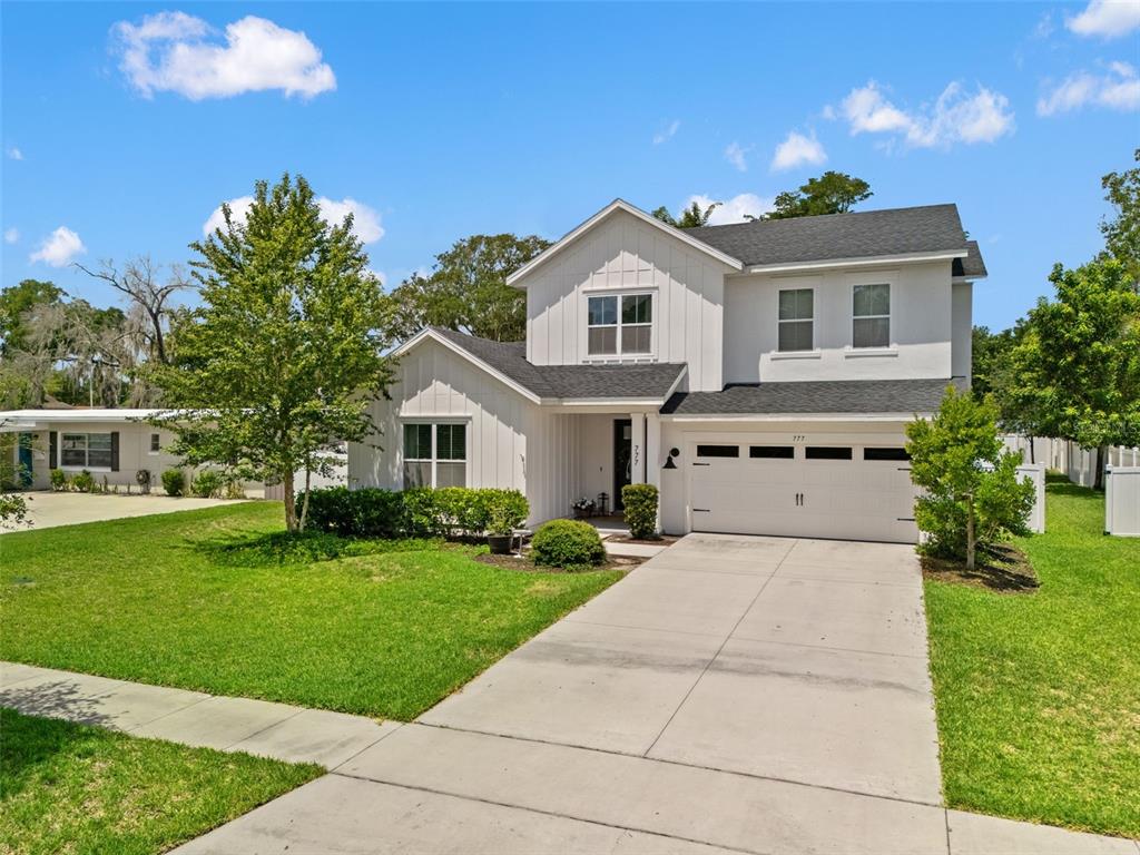 A two-story white house with a two-car garage and a concrete driveway — 777 HALIFAX AVENUE, WINTER PARK, FL