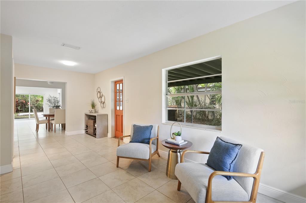 A living area features light tile floors, two armchairs, a side table, and a window — 6311 37TH AVENUE N, ST PETERSBURG, FL