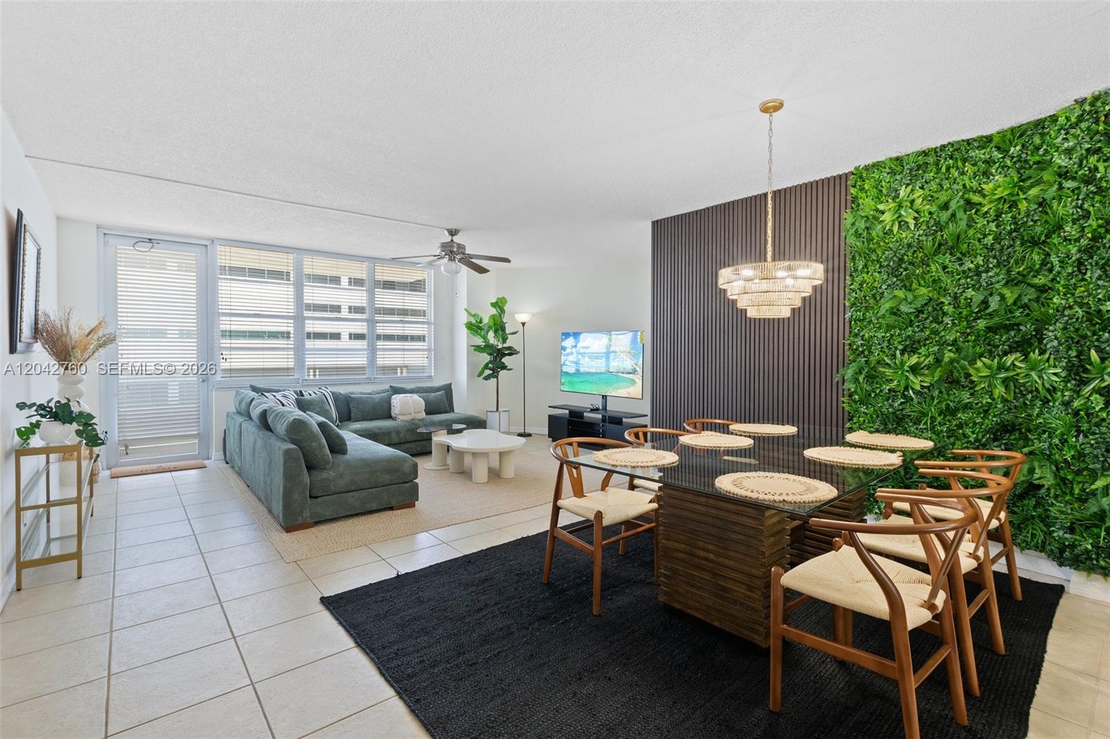 A living and dining area features a green wall, wood paneling, and a glass table — 3725 S Ocean Dr # 921, Hollywood FL 33019, HOLLYWOOD, FL