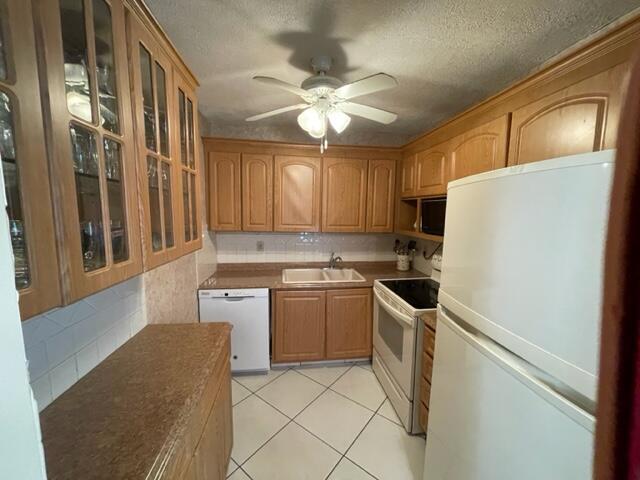 A kitchen with light wood cabinets, white appliances, a ceiling fan, and tiled flooring — 350 Horizons E # 206, Boynton Beach FL 33435, BOYNTON BEACH, FL