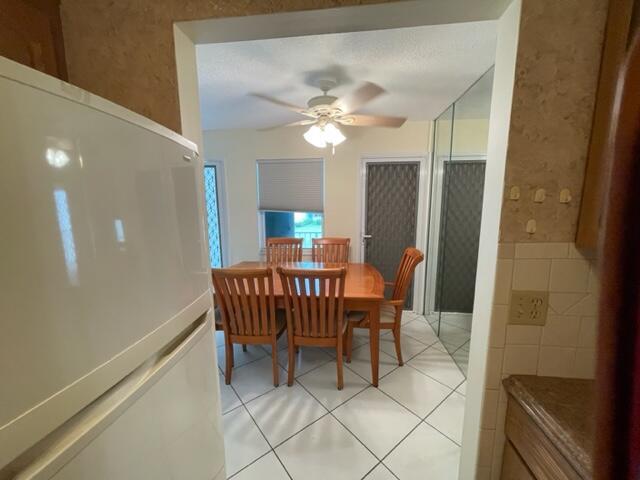 A dining area with a wooden table and chairs is visible through a kitchen doorway — 350 Horizons E # 206, Boynton Beach FL 33435, BOYNTON BEACH, FL