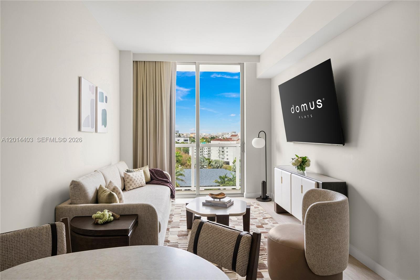 A living room features a sofa, television, coffee table, and a balcony with city views — 1611 SW 2nd Ave # 314, Miami FL 33129, MIAMI, FL