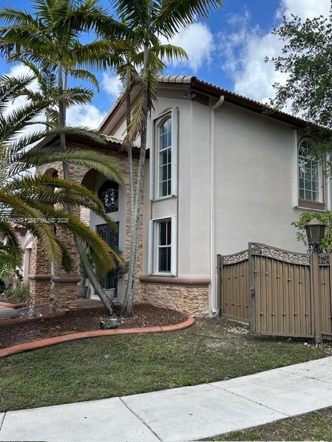 A two-story house with a stone facade, palm trees, and a metal gate — 1331 SW 153rd Path, Miami FL 33194, MIAMI, FL