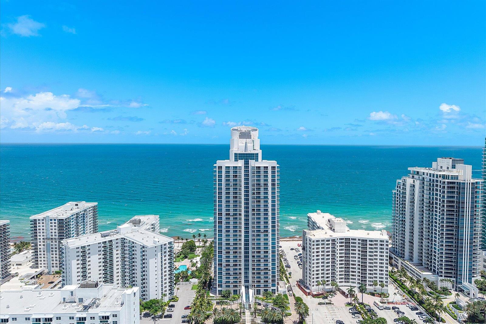 An aerial view of high-rise residential buildings situated along a sandy beach and the ocean — 3101 S Ocean Drive # 2707, Hollywood FL 33019, HOLLYWOOD, FL