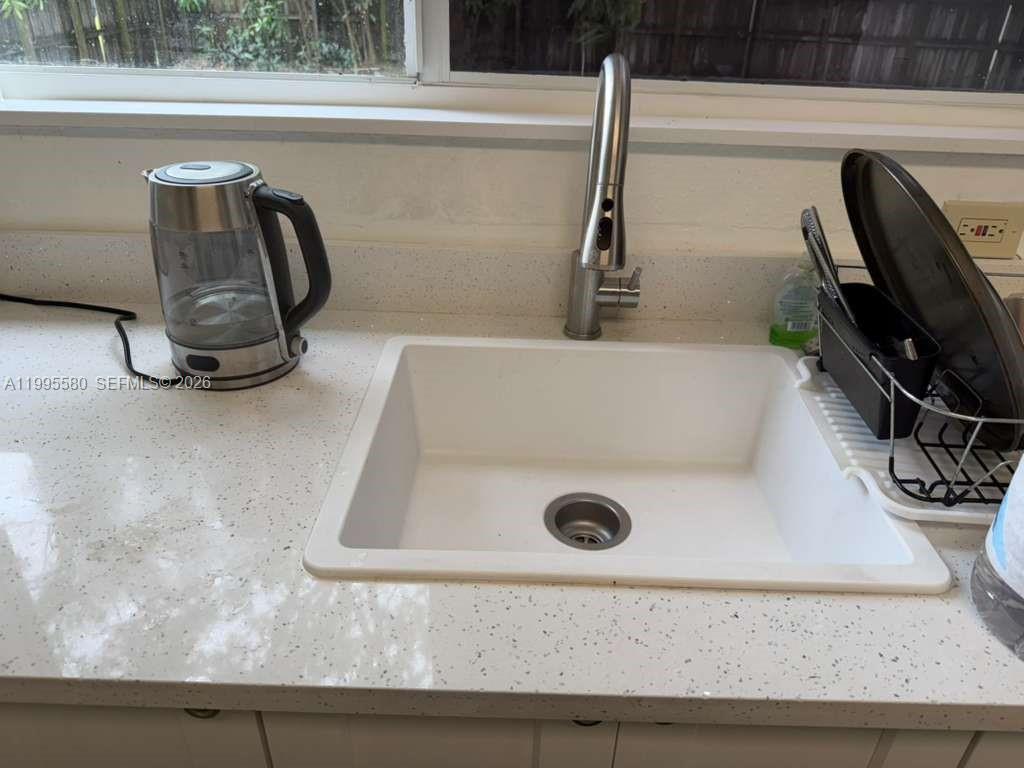 A kitchen sink with a modern faucet and a kettle on the countertop — 3 SW 7th Ave, Dania Beach FL 33004, DANIA BEACH, FL